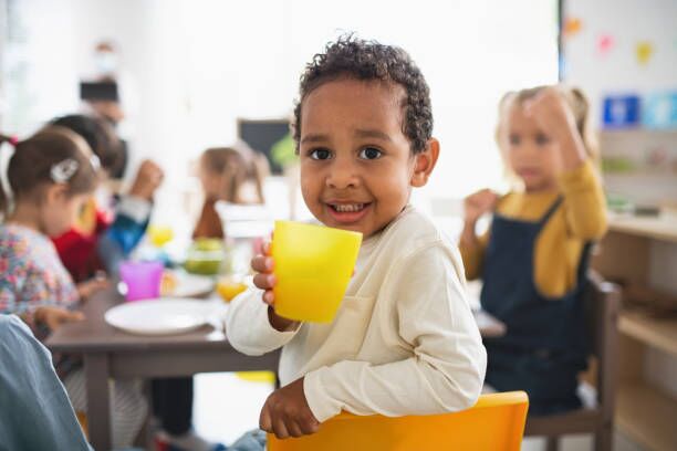 About Us A happy child enjoying mealtime at an early learning centre in Perth, highlighting the nurturing environment of top childcare centres in Perth.