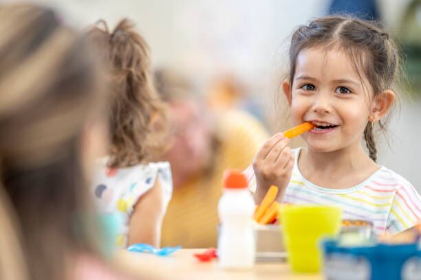 About Us A young child enjoying a healthy snack at a childcare centre in Perth, promoting nutritious eating habits in a quality early learning environment.