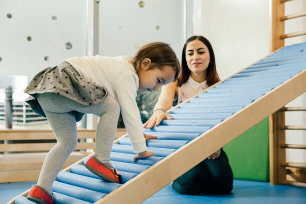 About Us A childcare educator supporting a child’s development at an early learning centre in Perth.